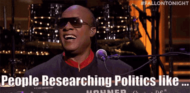 a man singing into a microphone with the words people researching politics like written below him