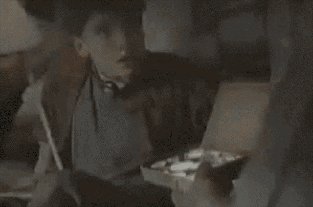 a boy is holding a box with coins in it and asking is this your silver