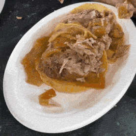 a white plate topped with meat and sauce