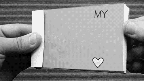 a person is holding a piece of paper that says my with a heart on it
