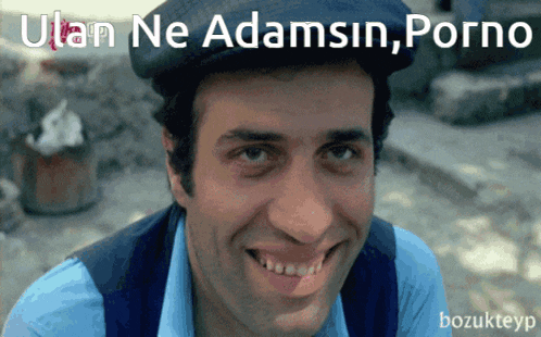a man wearing a hat is smiling with the words ulan ne adamsin porno behind him