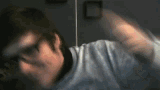 a blurry picture of a man 's face and arm