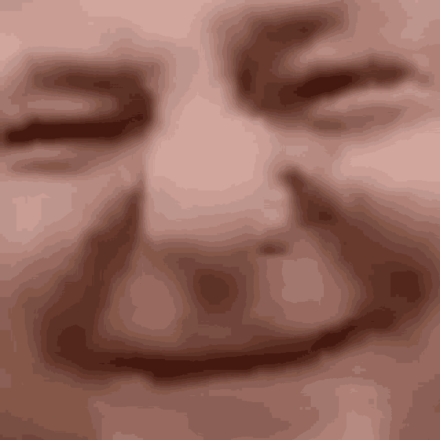a close up of a man 's face with his eyes closed and a smile on his face .