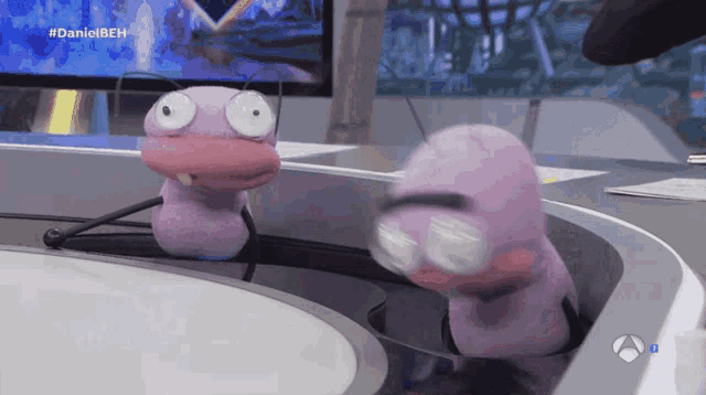 two stuffed animals are sitting on a table with the hashtag #danielbeh on the bottom