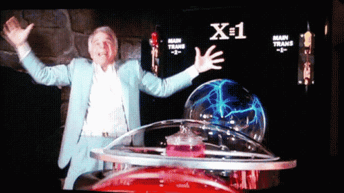 a man in a blue suit is standing in front of a screen that says x = 1