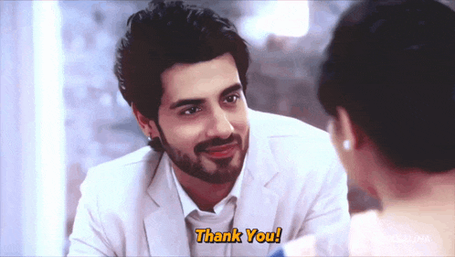 a man in a white suit says thank you