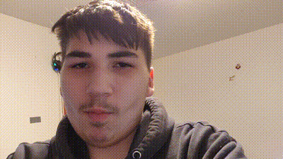 a young man is taking a selfie in a room while wearing a hoodie and headphones .