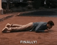 a man is laying on his stomach on a brick sidewalk and says `` finally '' .