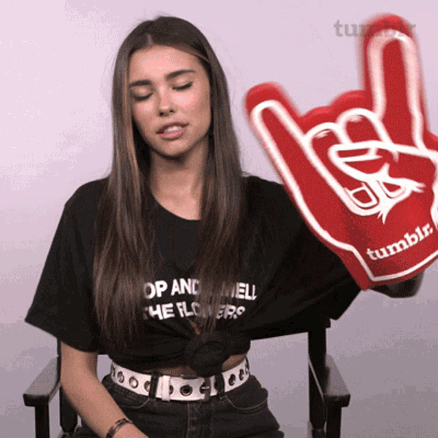 a woman wearing a black shirt that says " hop and hell "