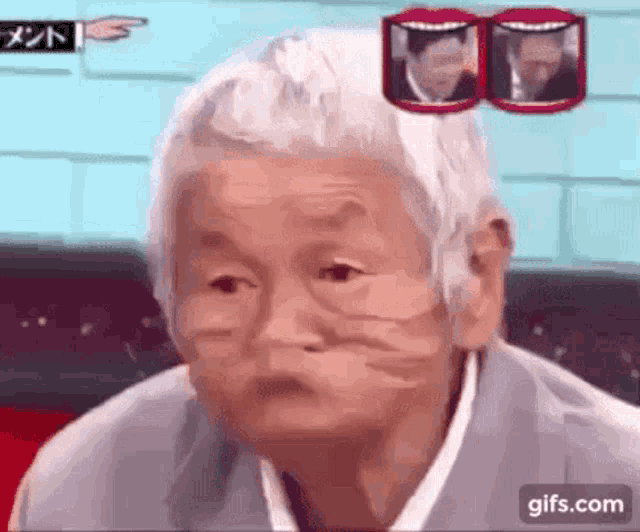 an elderly woman with gray hair is making a funny face in front of a man in a suit