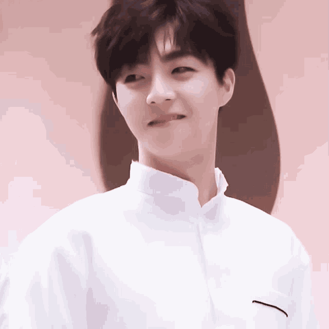 a young man wearing a white shirt with a black pocket