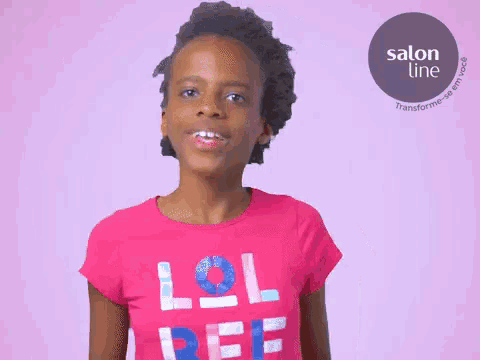 a girl wearing a pink shirt that says lol on it