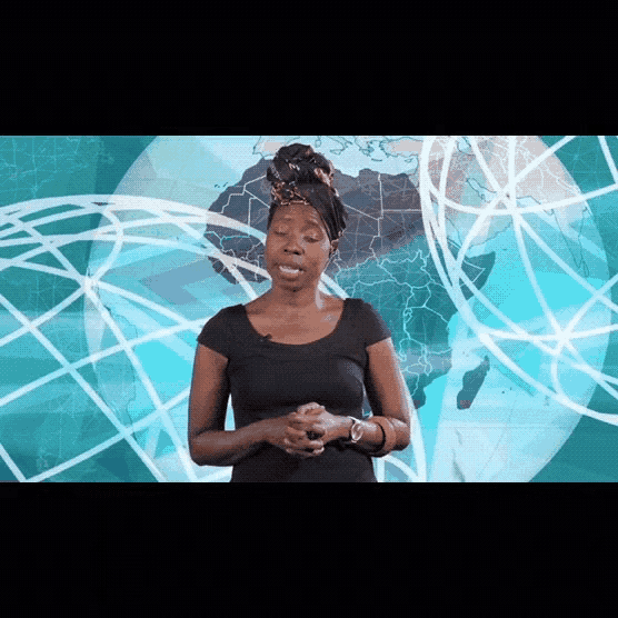 a woman stands in front of a globe with a map in the background