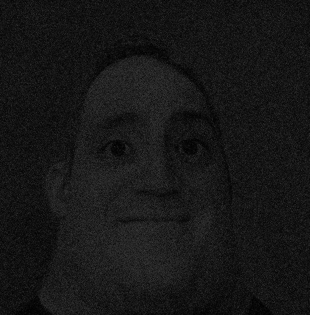 a close up of a person 's face in a dark room