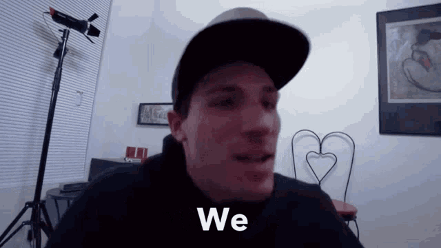 a man wearing a baseball cap says we