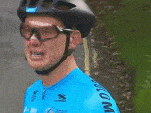 a man wearing a helmet and goggles is wearing a blue shirt that says ' s ' on the sleeve .