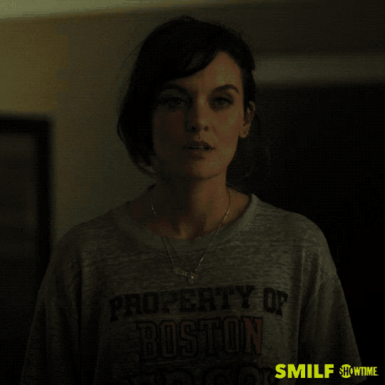 a woman wearing a property of boston t-shirt says " i 'm team ally "