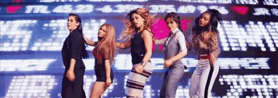 a group of women are standing next to each other on a stage .