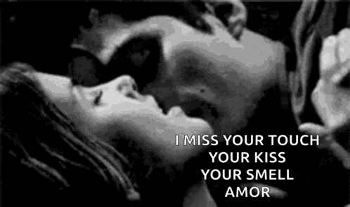 a black and white photo of a man and woman kissing with a quote .