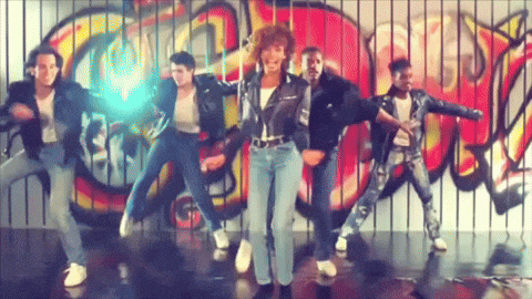 a group of people are dancing in front of a graffiti wall that says ' candy '