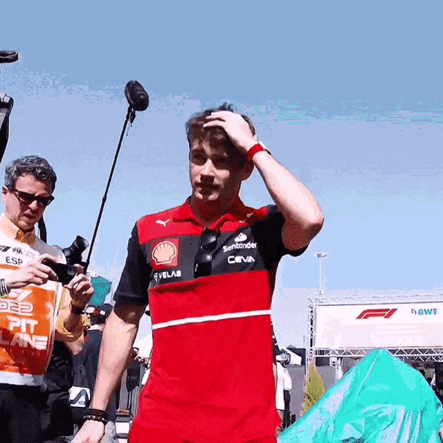 a man wearing a red and black shirt that says teva