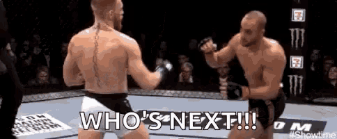 two men are fighting in a boxing ring and the words `` who 's next '' are visible .