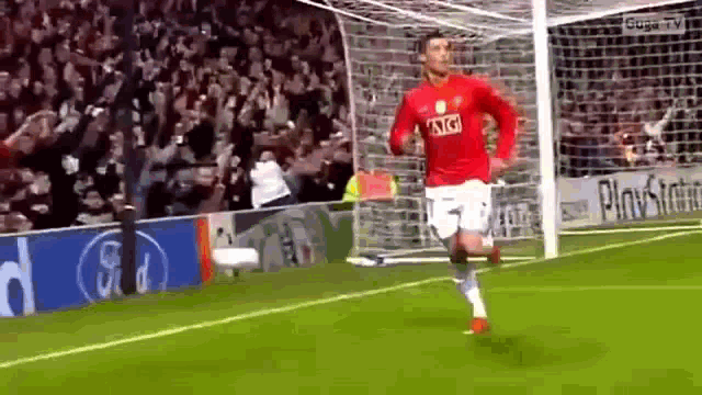 a soccer player wearing a red at & t shirt is running on a field .
