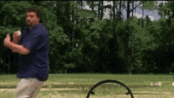 a man in a blue shirt is throwing a ball