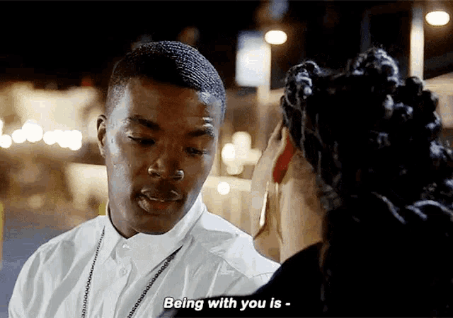a man and a woman are looking at each other and the man is saying being with you is