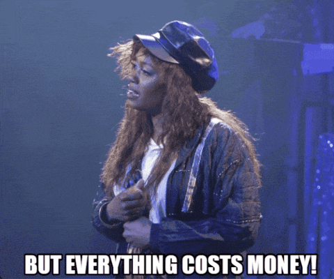 a woman singing into a microphone with the words but everything costs money