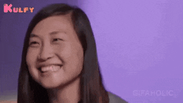 a close up of a woman 's face with a purple background and the words kulfy and gifaholic on the bottom