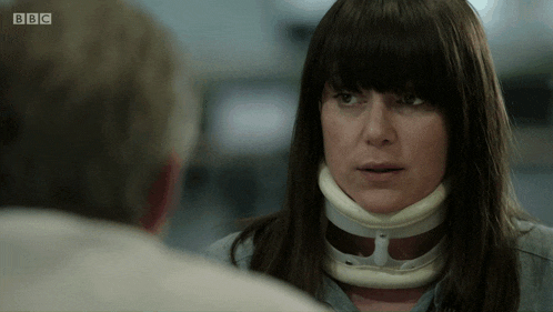 a woman with a collar around her neck talks to a man on bbc
