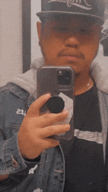 a man taking a picture of himself with a phone with the word eau on it