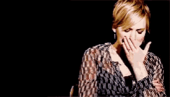 a woman in a striped shirt is making a face
