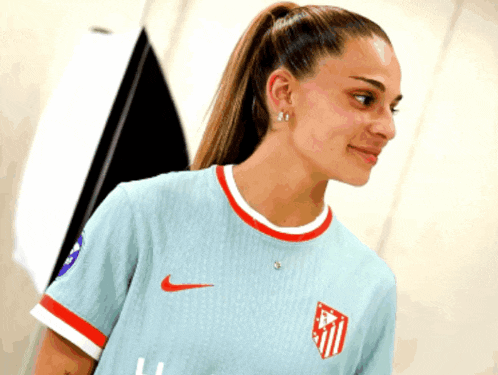 a woman wearing a light blue nike shirt
