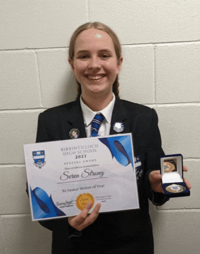 a girl is holding a certificate that says ' sern strong ' on it