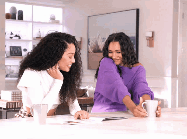 a woman in a purple sweater sits at a table with two other women