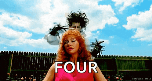 a man is cutting a woman 's hair and the word four is on the bottom