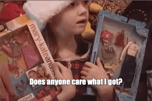 a little girl is holding a barbie doll and says does anyone care what i got ?