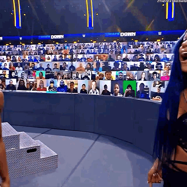 a woman stands in front of a screen that says ' smash down ' on it