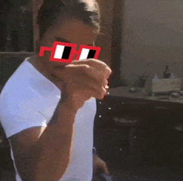 a man wearing a white shirt and red sunglasses with the letter h on the lens