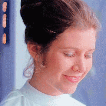 a close up of a woman 's face with a bun and a smile on her face .