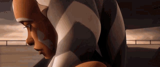 a close up of a woman 's face with a striped shirt on