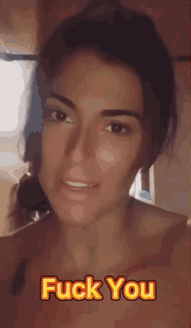 a close up of a woman 's face with the words fuck you below it