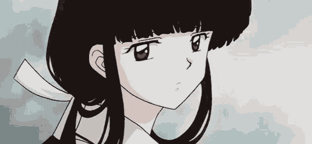 a drawing of a girl with long black hair and red eyes looking down .