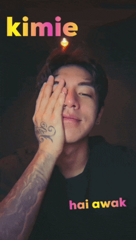 a man with a tattoo on his arm covering his face with his hand and the words " kimie hai awak " written above him