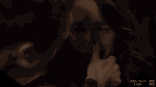 a woman is crying while a man holds her hand