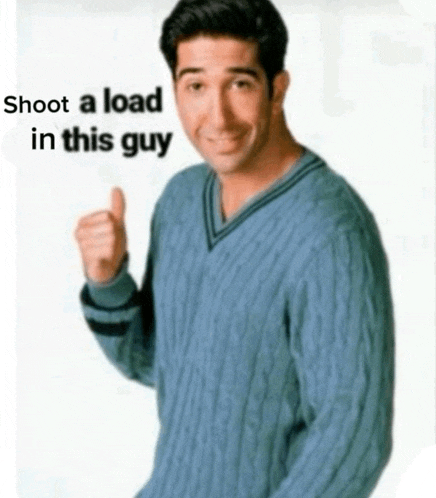 a man in a blue sweater is giving a thumbs up with the words shoot a load in this guy above him