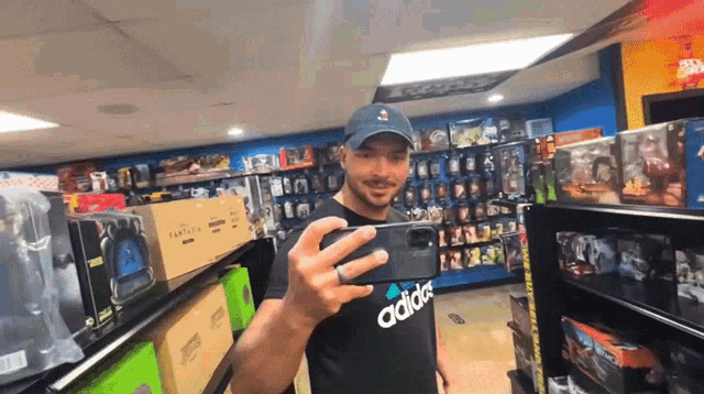 a man in an adidas shirt takes a selfie
