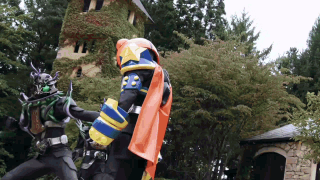a man in a costume with the number 33 on his chest is fighting another man